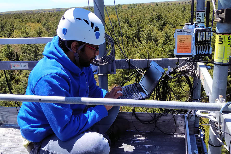 Researcher working with machinery in the field